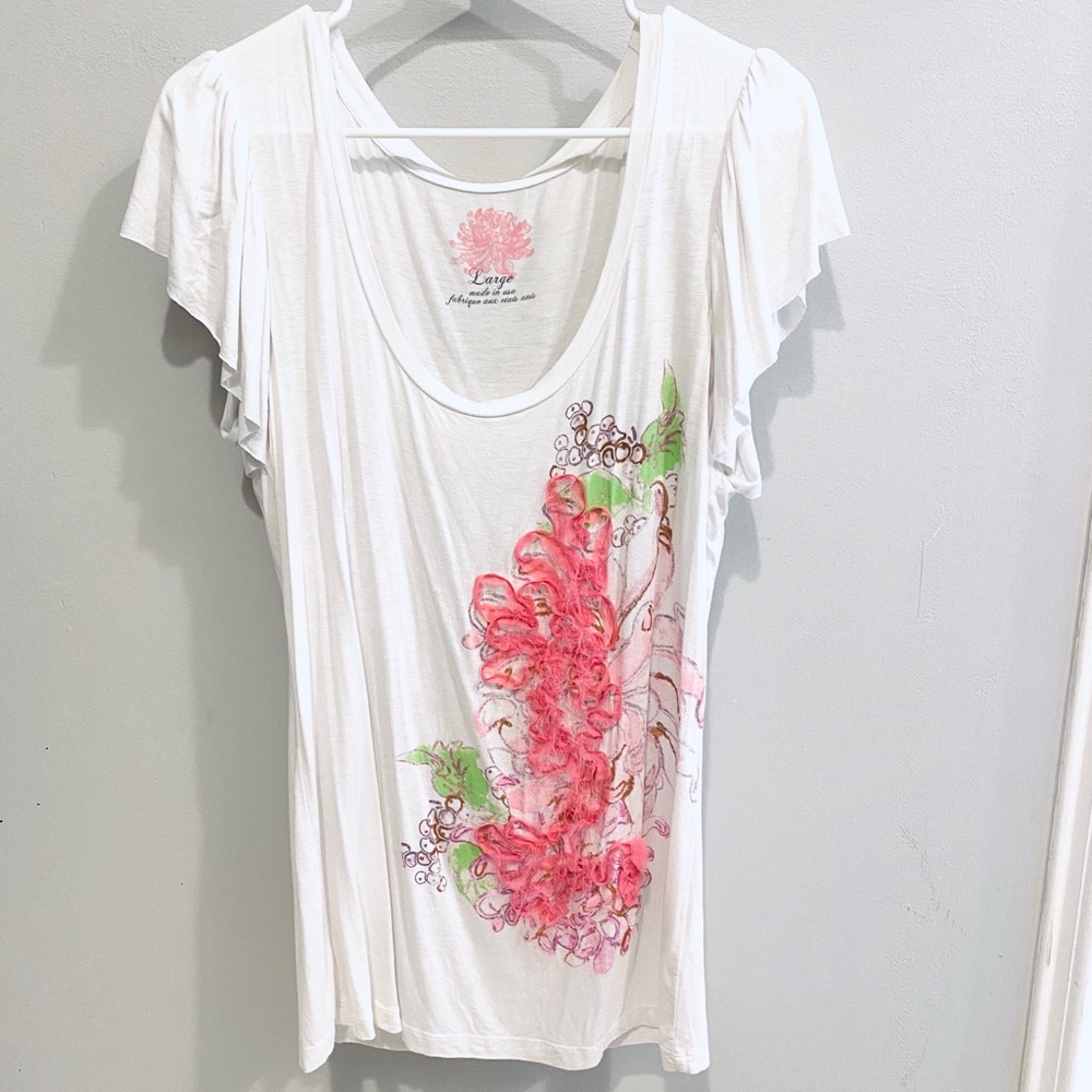 White graphic tee with pink flower application.